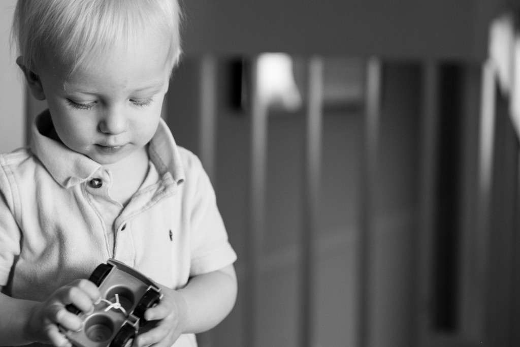 Documentary family photography kelowna, looking at toy